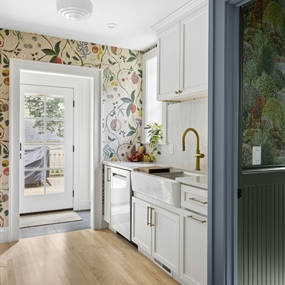 Minneapolis kitchen renovation featuring white shaker cabinets, wood flooring, and a doorway to the powder room.